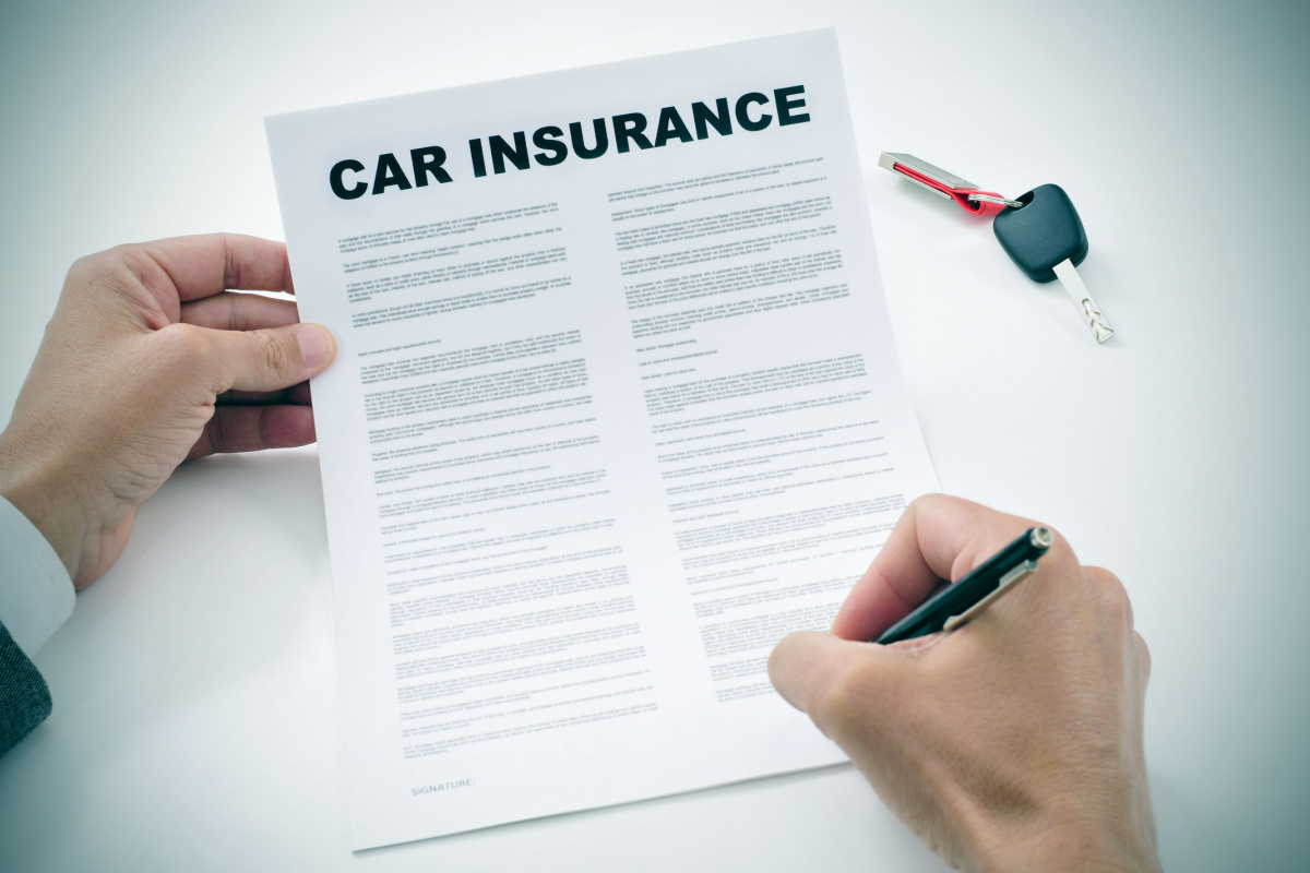 Driver filling out car insurance paperwork