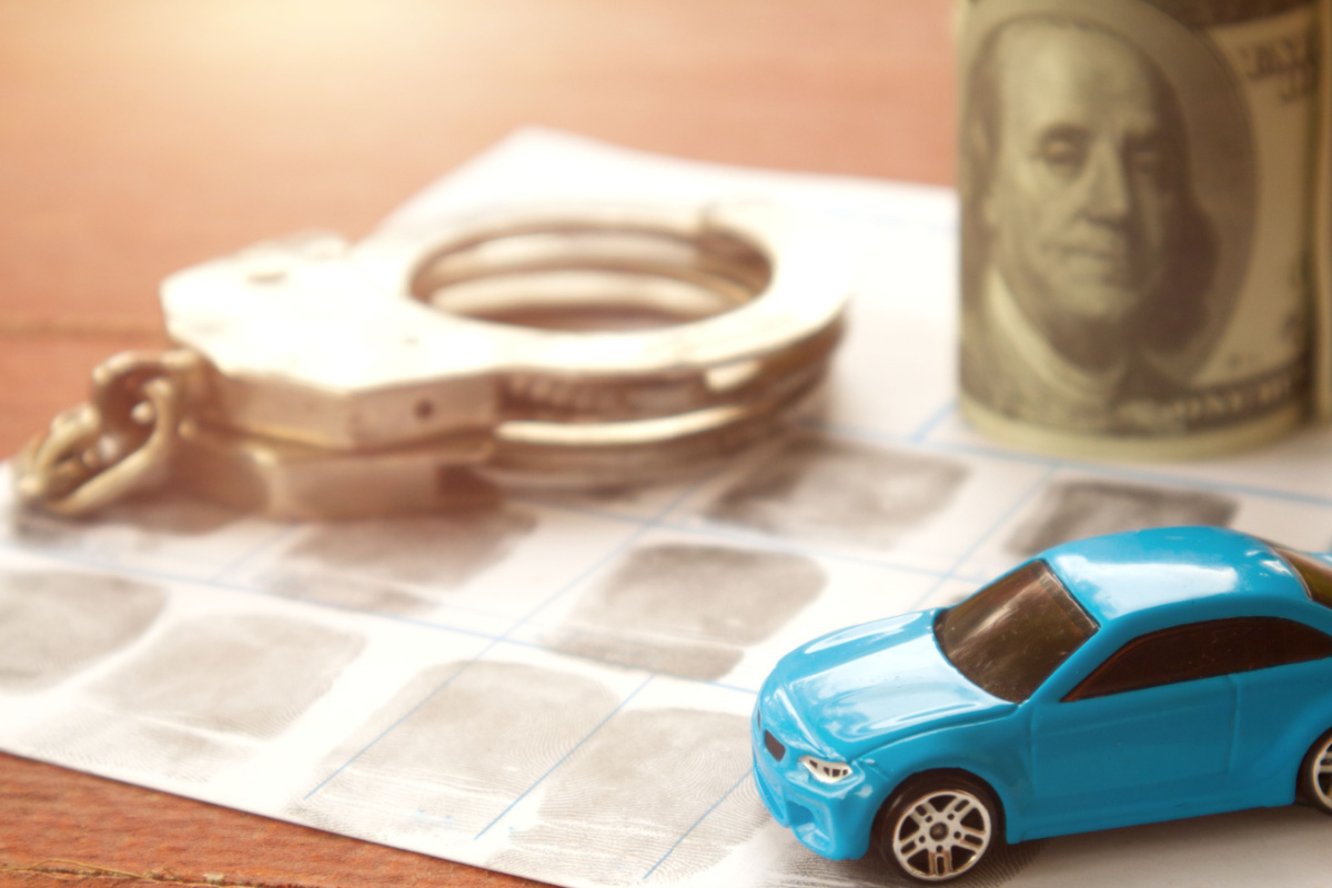 Toy car, roll of $100 bills, and handcuffs