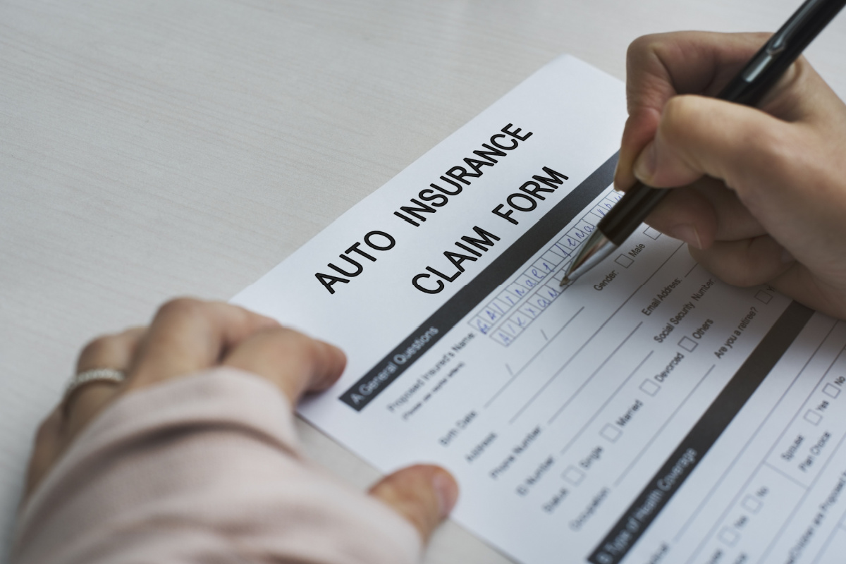 Driver filling out insurance claim form